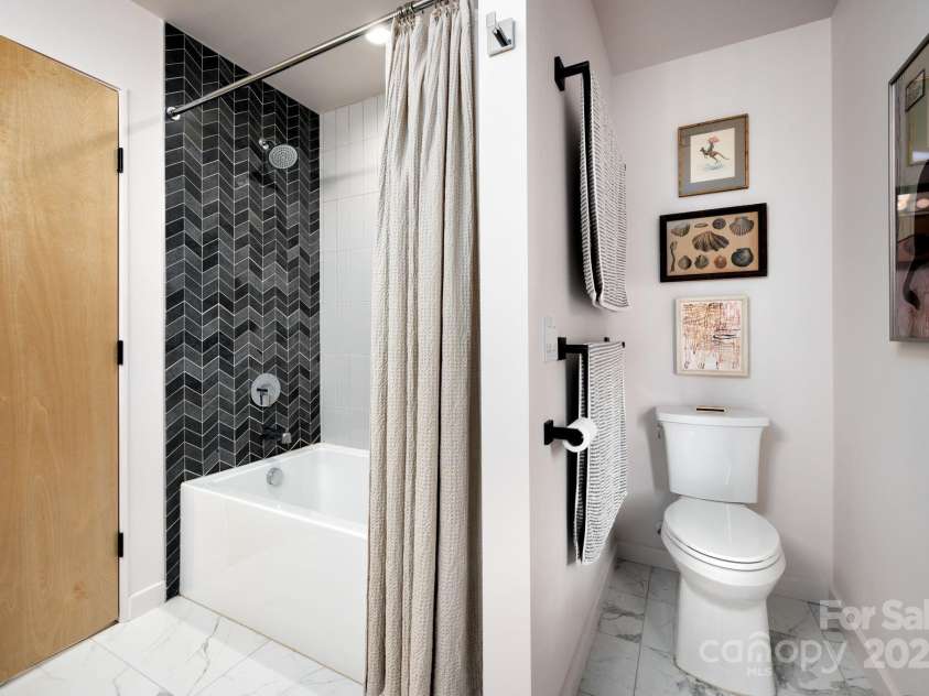 26 Winnfred Street, Asheville, NC 28806.  MLS# CAR4293290, YatesRealty ID 34446. Beautifully Tiled Shower + Tub