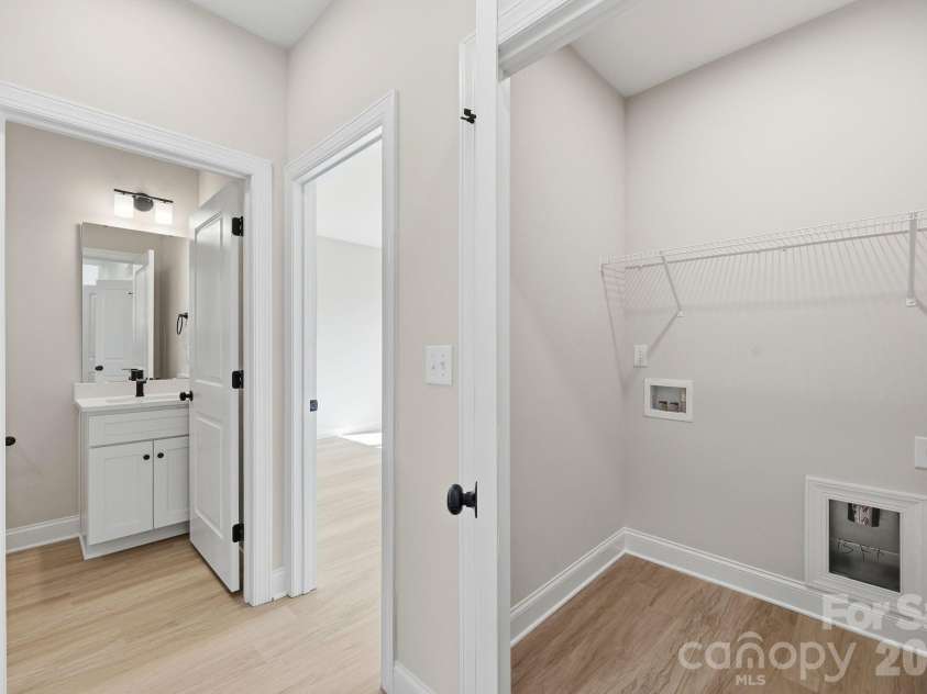 1962 Redwood Drive, Oakboro, NC 28129.  MLS# CAR4399195, YatesRealty ID 34448. View from hall; Laundry and secondary bathroom
