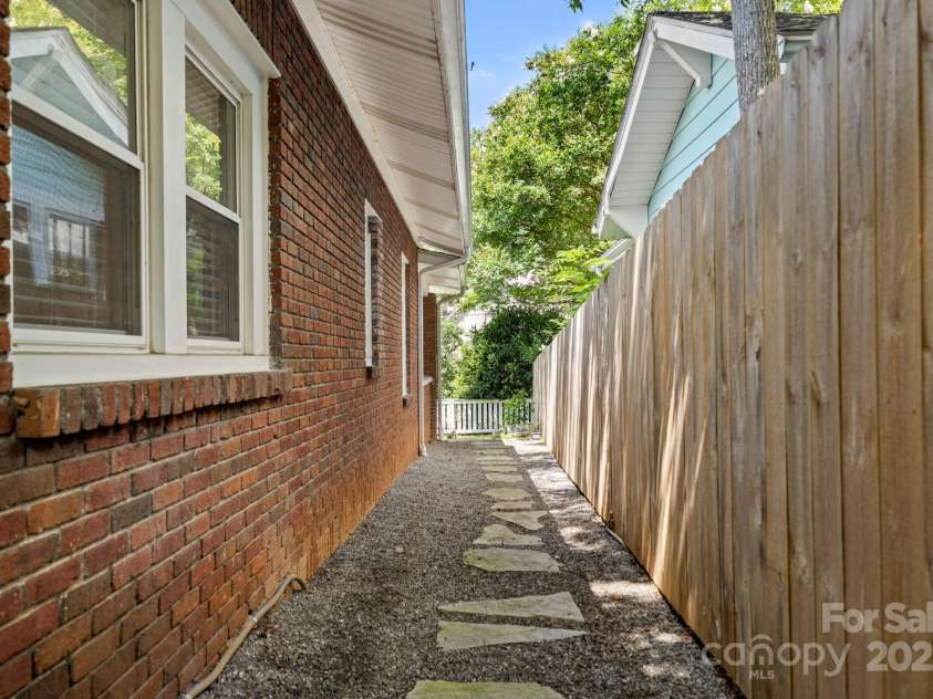 77 Mitchell Avenue, Asheville, NC 28806.  MLS# CAR4285971, YatesRealty ID 34450. Easily access both the front and back yards- fully fenced and great for kids and pets.