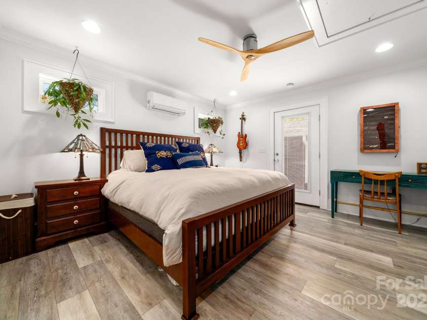 77 Mitchell Avenue, Asheville, NC 28806.  MLS# CAR4285971, YatesRealty ID 34450. Primary bedroom that could also be used as a guest suite with private entrance from the outside patio.