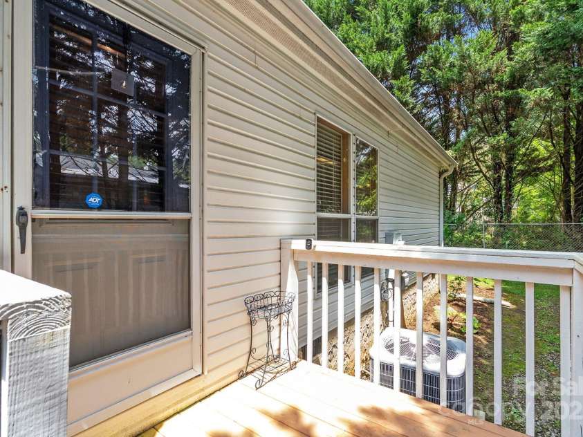 213 Old State Ten Road, Black Mountain, NC 28711.  MLS# CAR4294666, YatesRealty ID 34482. Step out onto the back porch and enjoy a private outdoor retreat surrounded by mature trees. This cozy spot is perfect for a morning coffee, an evening unwind, or simply taking in the peaceful setting.