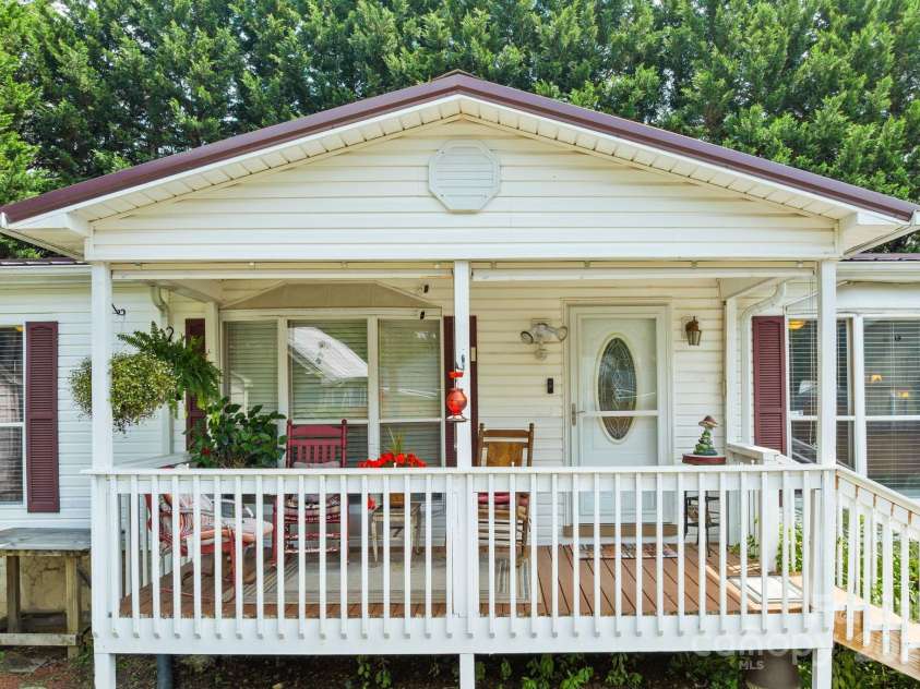 213 Old State Ten Road, Black Mountain, NC 28711.  MLS# CAR4294666, YatesRealty ID 34482. The covered porch provides shade and shelter, making it usable in every season. This is a space where you’ll want to slow down, relax, and truly feel at home!