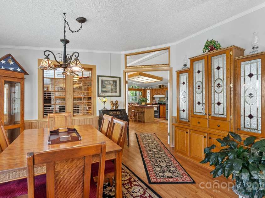 213 Old State Ten Road, Black Mountain, NC 28711.  MLS# CAR4294666, YatesRealty ID 34482. The dining room is both elegant and inviting. It's the perfect atmosphere for family meals or entertaining guests. Natural wood trim and warm flooring tie the space together, while the open flow into the kitche
