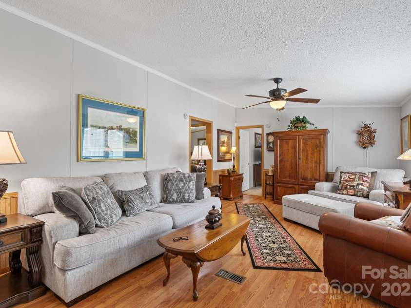 213 Old State Ten Road, Black Mountain, NC 28711.  MLS# CAR4294666, YatesRealty ID 34482. The inviting layout and seamless flow through the heart of the home. Neutral tones, wood-style flooring, and abundant natural light create a warm, welcoming atmosphere that’s perfect for both everyday comfort a