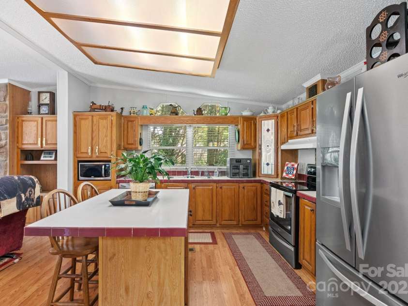 213 Old State Ten Road, Black Mountain, NC 28711.  MLS# CAR4294666, YatesRealty ID 34482. This bright and functional kitchen offers abundant cabinetry, updated stainless steel appliances—including a self-cleaning oven.