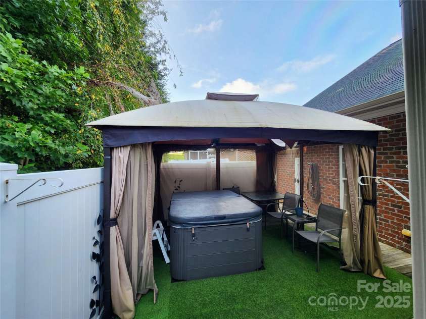 100 Wentworth Drive, Mocksville, NC 27028.  MLS# CAR4296498, YatesRealty ID 34495. Hot tub and canopy will convey. New canopy cover (not installed) will also convey