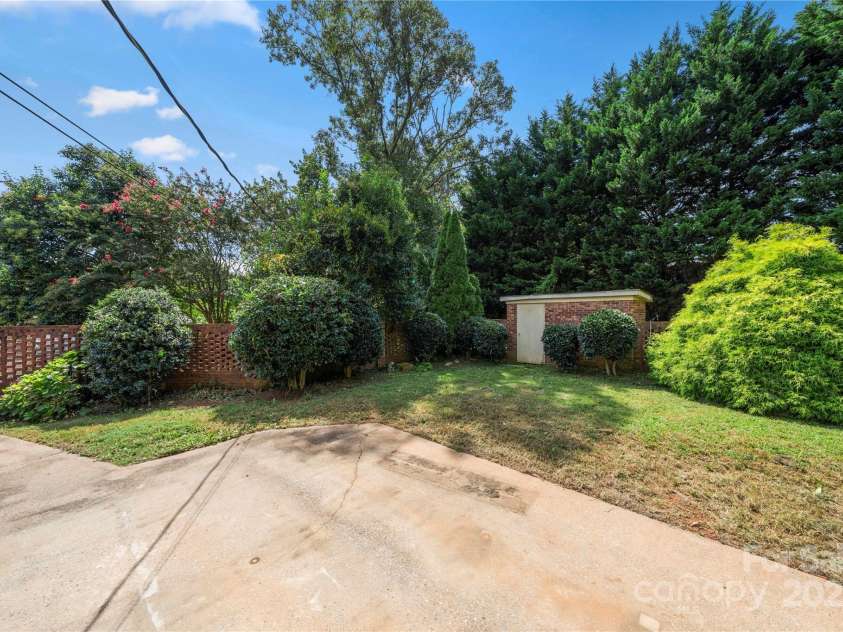205 Gaston Avenue, Bessemer City, NC 28016.  MLS# CAR4296266, YatesRealty ID 34504. Large brick fenced back yard