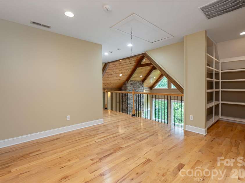 33 Bridle Path Drive, Barnardsville, NC 28709.  MLS# CAR4378002, YatesRealty ID 34516. 2nd level sitting area with built ins provide valuable storage