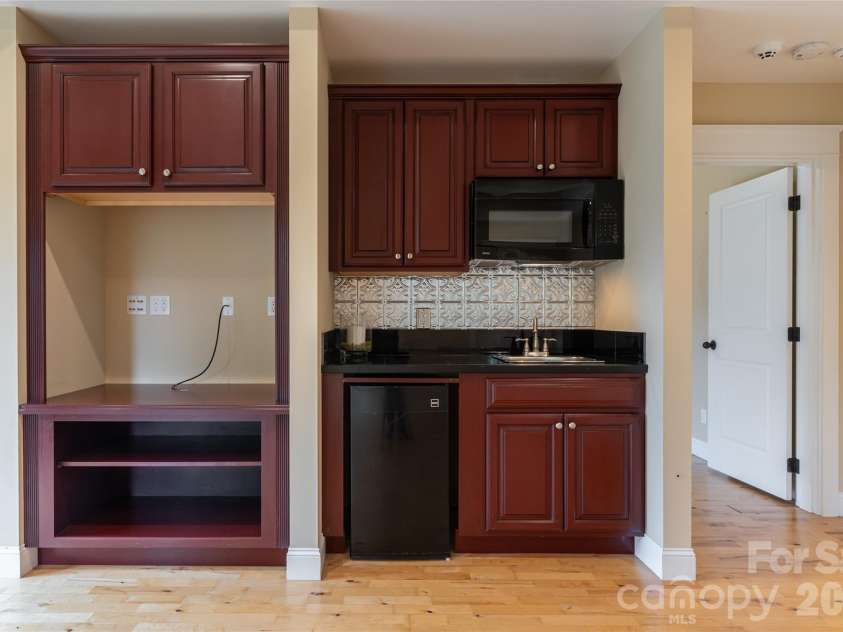33 Bridle Path Drive, Barnardsville, NC 28709.  MLS# CAR4378002, YatesRealty ID 34516. Lower level includes a kitchenette, a third fireplace, private guest room and guest bathroom