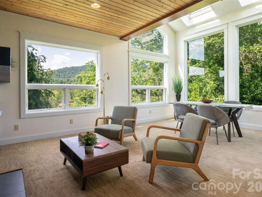 33 Bridle Path Drive, Barnardsville, NC 28709.  MLS# CAR4378002, YatesRealty ID 34516. This formal dining room features an additional entertaining area and a second fireplace, creating an atmosphere of true luxury.