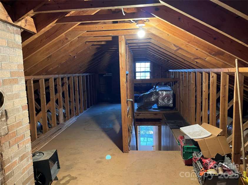 8725 Bringle Ferry Road, Salisbury, NC 28146.  MLS# CAR4218468, YatesRealty ID 3454. Attic w/stationary stairs center-right