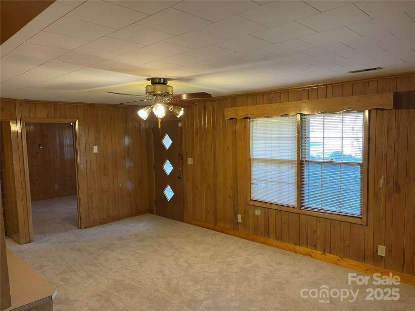 8725 Bringle Ferry Road, Salisbury, NC 28146.  MLS# CAR4218468, YatesRealty ID 3454. Living room from side door area. Front door at center. 