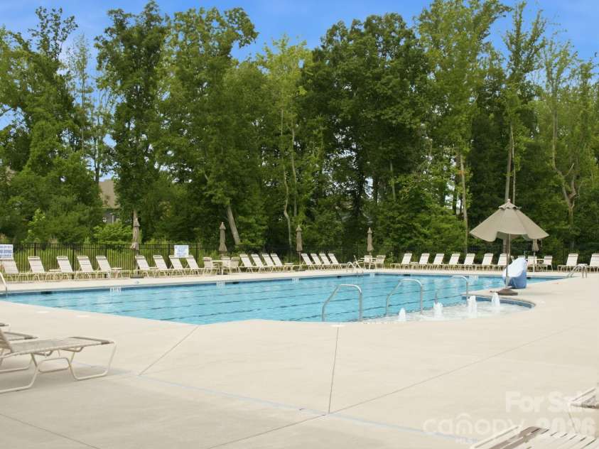 4047 Havenport Circle, Tega Cay, SC 29708.  MLS# CAR4394582, YatesRealty ID 34585. Pool nestled among the trees