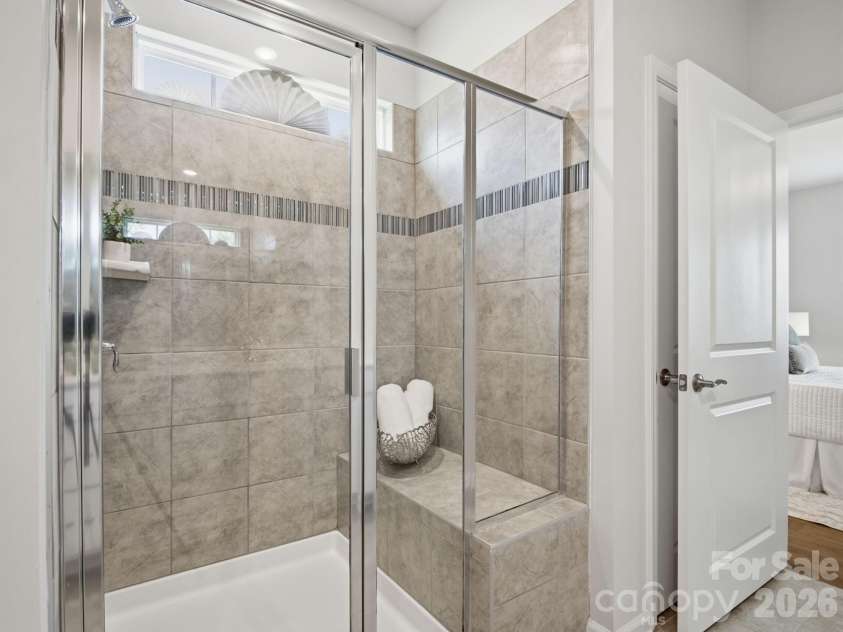 4047 Havenport Circle, Tega Cay, SC 29708.  MLS# CAR4394582, YatesRealty ID 34585. Tile shower with bench