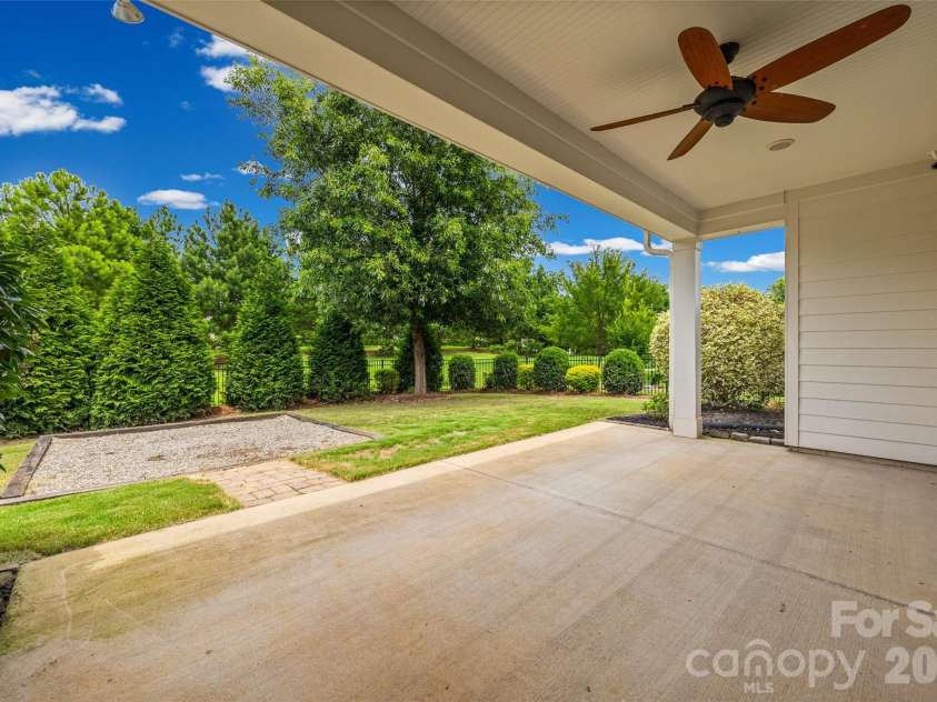 12021 Grey Partridge Drive, Charlotte, NC 28278.  MLS# CAR4396177, YatesRealty ID 34589. Large covered back deck looking out to the private backyard.