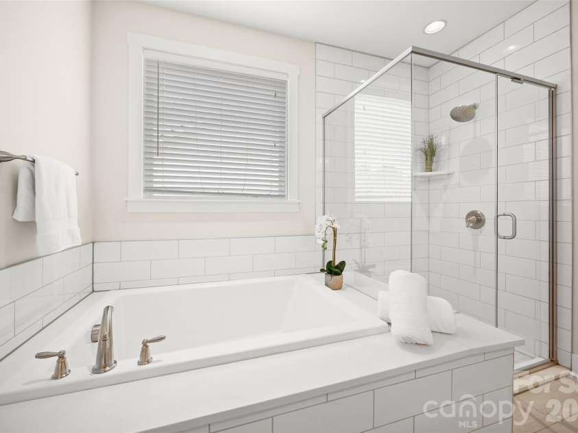 12021 Grey Partridge Drive, Charlotte, NC 28278.  MLS# CAR4396177, YatesRealty ID 34589. Nice soaking tub and glass shower.