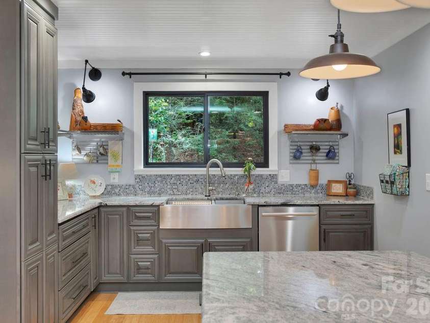 3125 Connestee Trail, Brevard, NC 28712.  MLS# CAR4396358, YatesRealty ID 34599. Open shelving, high end cabinetry & a window to the back yard