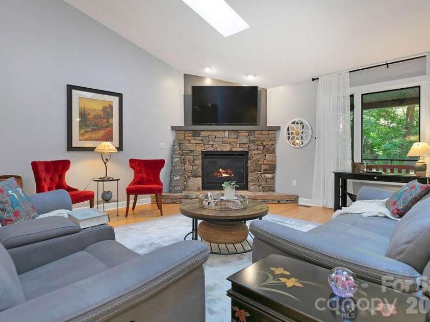 3125 Connestee Trail, Brevard, NC 28712.  MLS# CAR4396358, YatesRealty ID 34599. Stone fireplace with gas logs