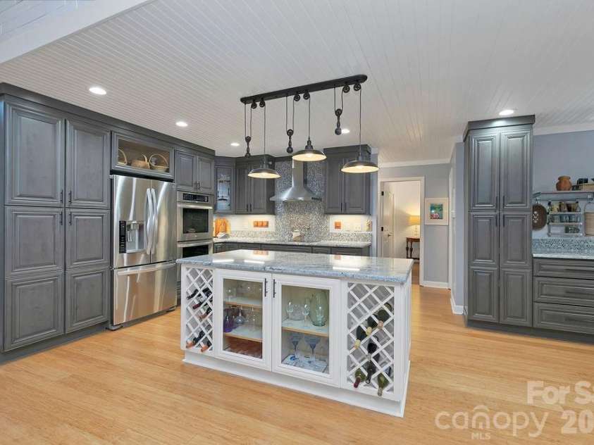 3125 Connestee Trail, Brevard, NC 28712.  MLS# CAR4396358, YatesRealty ID 34599. The massive island offers storage & a great spot for entertaining
