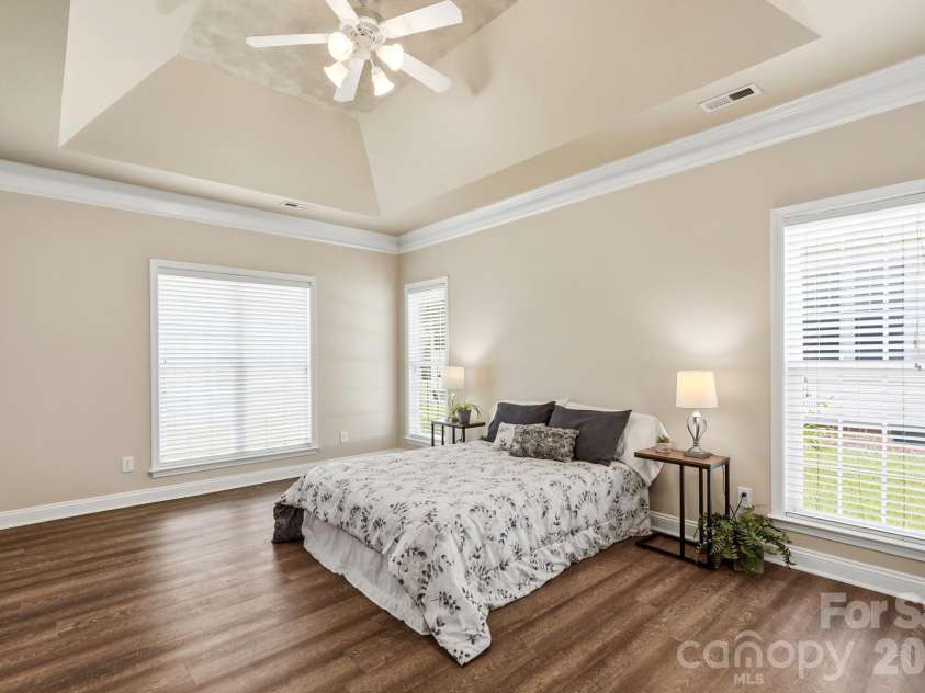 208 Harris Farm Road, Mooresville, NC 28115.  MLS# CAR4396812, YatesRealty ID 34609. Main-level primary suite with tray ceiling and spa-inspired bath