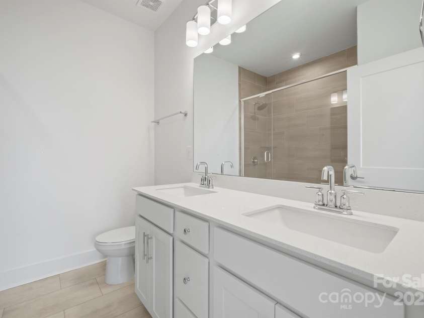 4018 Capital Ridge Court, Charlotte, NC 28205.  MLS# CAR4196575, YatesRealty ID 34613. Primary bath with dual sinks & walk-in shower