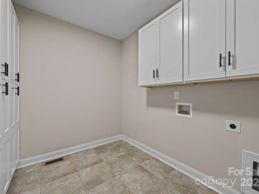 6802 Rock Island Road, Charlotte, NC 28278.  MLS# CAR4289658, YatesRealty ID 34622. Laundry with storage cabinets