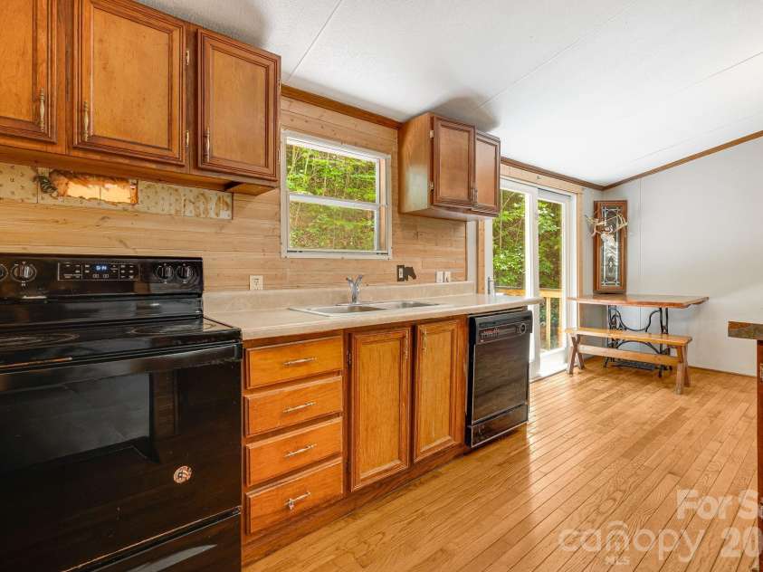 94 Long Ridge Road, Candler, NC 28715.  MLS# CAR4385586, YatesRealty ID 34628. Kitchen opens to back deck so it's simple to transfer from grill to dinner table!