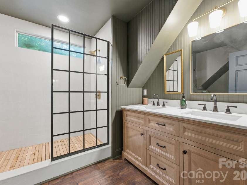 3819 Flat Mountain Road, Highlands, NC 28741.  MLS# CAR4397465, YatesRealty ID 34629. A beautifully appointed ensuite bath features a spacious walk-in shower, elegant vanity, and timeless designer finishes.