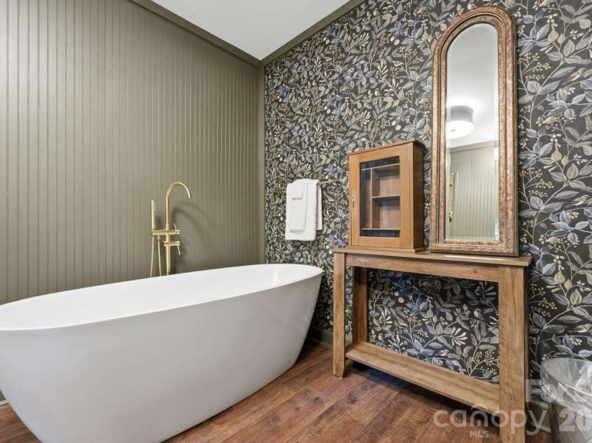 3819 Flat Mountain Road, Highlands, NC 28741.  MLS# CAR4397465, YatesRealty ID 34629. A striking botanical accent wall creates the perfect backdrop for the luxurious freestanding soaking tub, transforming every bath into a spa-like escape.
