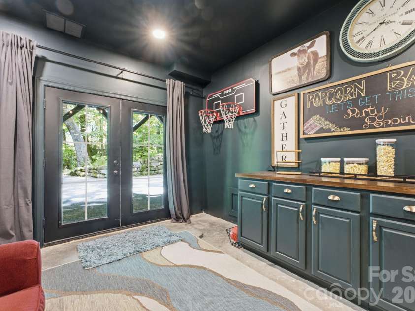 3819 Flat Mountain Road, Highlands, NC 28741.  MLS# CAR4397465, YatesRealty ID 34629. Game room with French doors providing easy access outdoors.