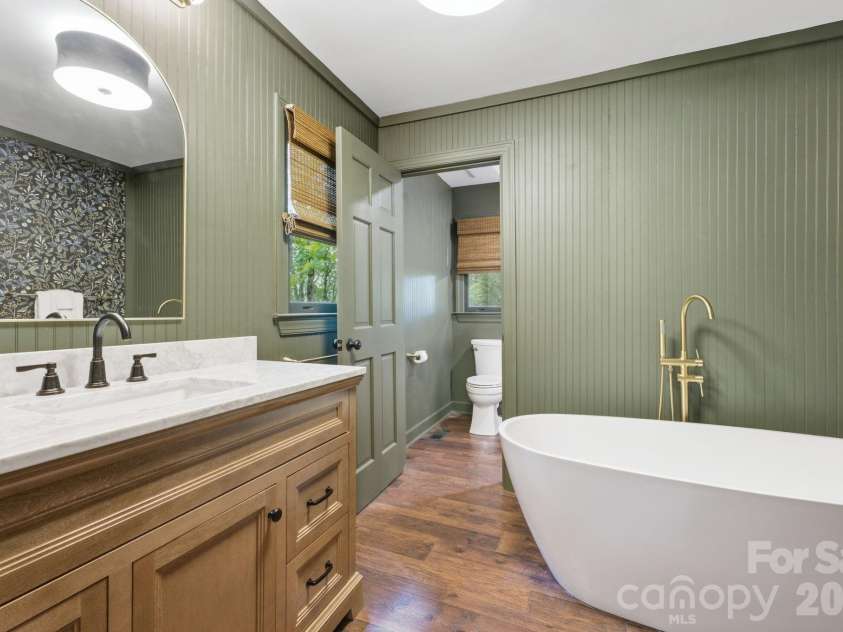 3819 Flat Mountain Road, Highlands, NC 28741.  MLS# CAR4397465, YatesRealty ID 34629. Indulge in the spa-inspired primary bath featuring dual vanities, a freestanding soaking tub, and designer finishes throughout.