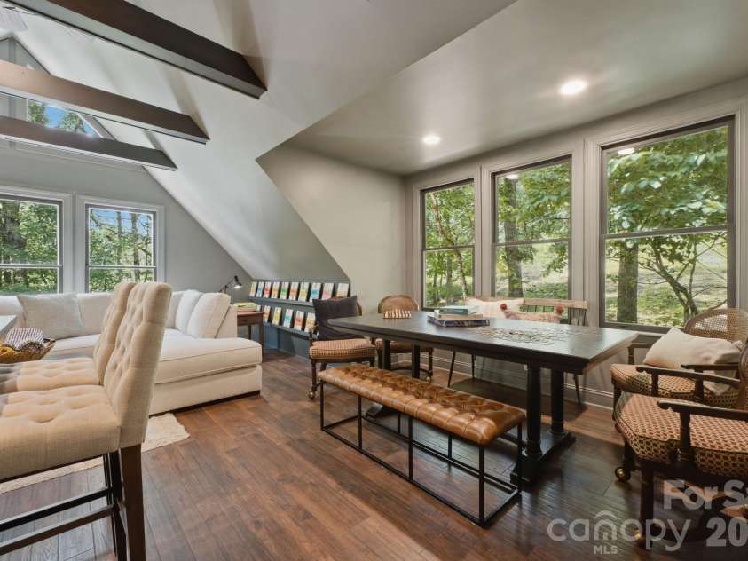 3819 Flat Mountain Road, Highlands, NC 28741.  MLS# CAR4397465, YatesRealty ID 34629. Natural light pours through expansive windows, while vaulted ceilings and a dedicated game table create the perfect setting for connection and conversation.