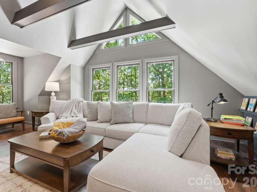 3819 Flat Mountain Road, Highlands, NC 28741.  MLS# CAR4397465, YatesRealty ID 34629. The spacious upper-level recreation room features vaulted ceilings, exposed beams, and an inviting atmosphere designed for gathering, entertaining, and making memories.