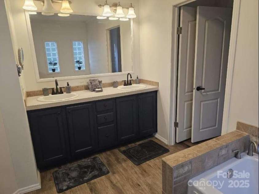 1597 Cleghorn Mill Road, Rutherfordton, NC 28139.  MLS# CAR4213254, YatesRealty ID 3463. Dual vanity in the primary bathroom and large soaking tub.