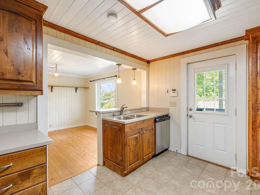 111 Bible School Road, Lake Lure, NC 28746.  MLS# CAR4399262, YatesRealty ID 34637. Kitchen looking out towards dining room