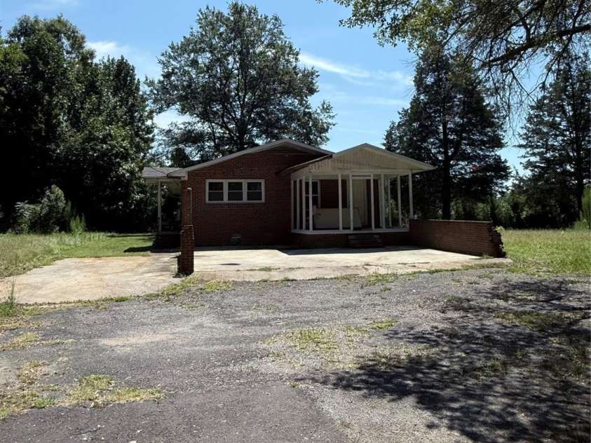 1556 Sam Smith Road, Fort Mill, SC 29708.  MLS# CAR4279108, YatesRealty ID 34638. Home on nearly 2 acres, large driveway and parking area with easy access to back door and side porch.