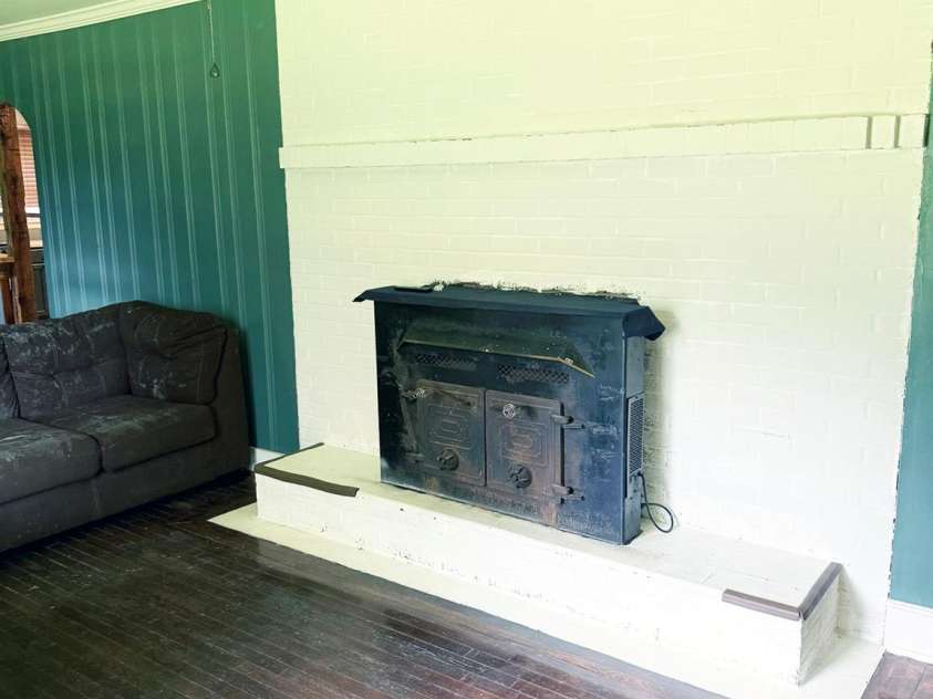 1556 Sam Smith Road, Fort Mill, SC 29708.  MLS# CAR4279108, YatesRealty ID 34638. Wood fireplace with electric fan in living room