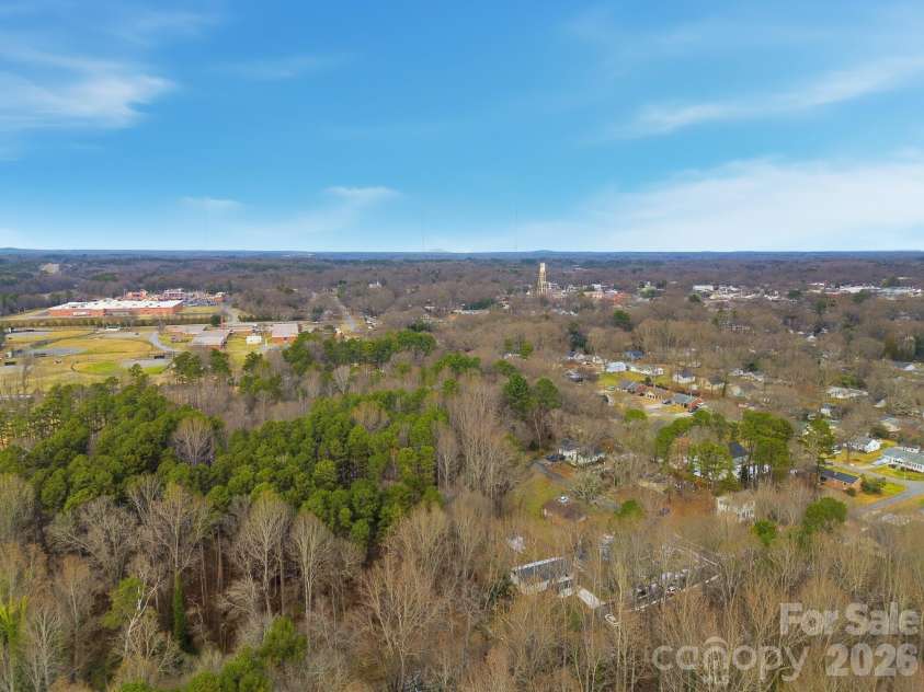 704 Border Street, Dallas, NC 28034.  MLS# CAR4342695, YatesRealty ID 3465. Aerial view of wooded area surrounding subject