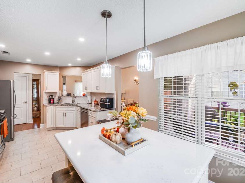 3319 Creek Trail Road, Indian Trail, NC 28079.  MLS# CAR4295633, YatesRealty ID 34657. Custom built in eat-in island/ bar with quartz counters.