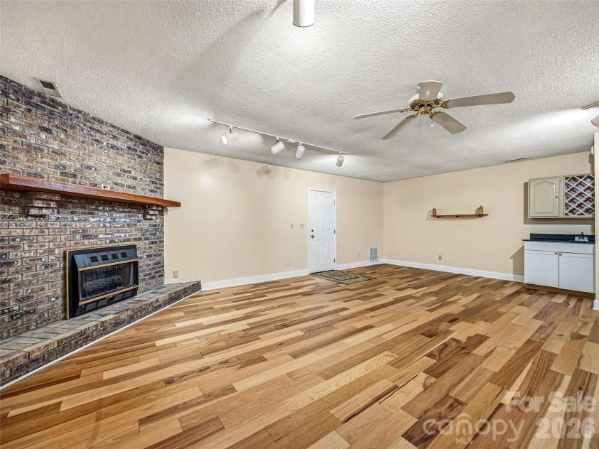 206 Camellia Way, Laurel Park, NC 28739.  MLS# CAR4398729, YatesRealty ID 34662. Fireplace in lower level