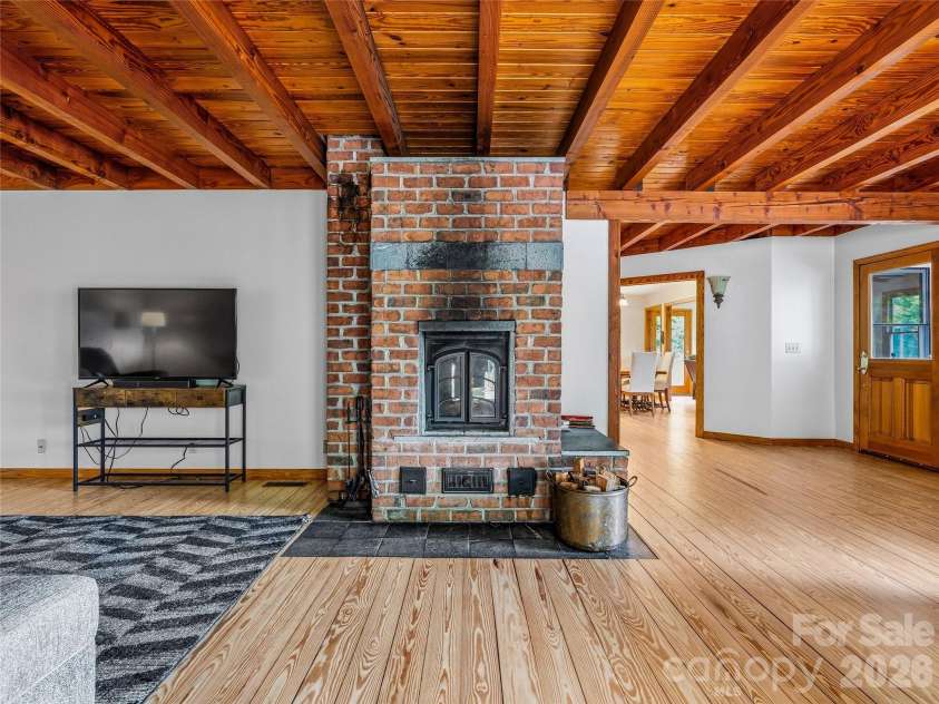 1856 Lickskillet Road, Burnsville, NC 28714.  MLS# CAR4396604, YatesRealty ID 34698. Den fireplace