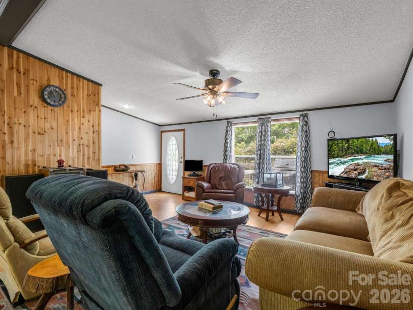2053 Nancy Mountain Road, Rosman, NC 28772.  MLS# CAR4381811, YatesRealty ID 347. Front living room from dining room