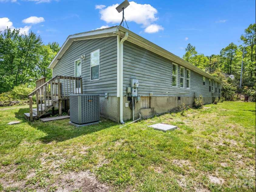 2053 Nancy Mountain Road, Rosman, NC 28772.  MLS# CAR4381811, YatesRealty ID 347. Side entrance and back, generator pad and hookup