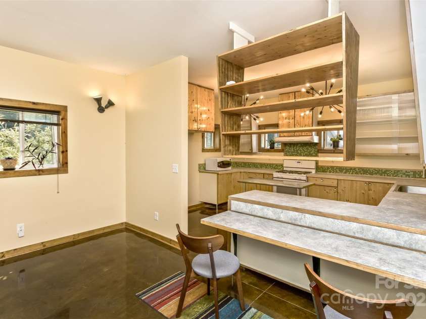 117 Old Dairy Drive, Leicester, NC 28748.  MLS# CAR4291419, YatesRealty ID 34700. In addition to the breakfast bar area, there is ample room for a separate dining table and chairs.