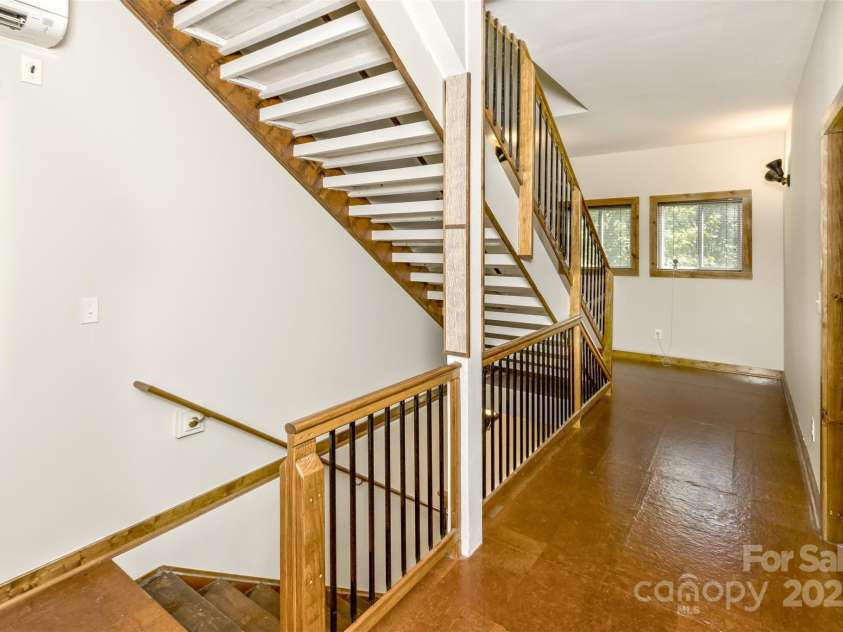 117 Old Dairy Drive, Leicester, NC 28748.  MLS# CAR4291419, YatesRealty ID 34700. The stairway to the third-floor bonus area is located at the end of the bedroom stair landing hallway.