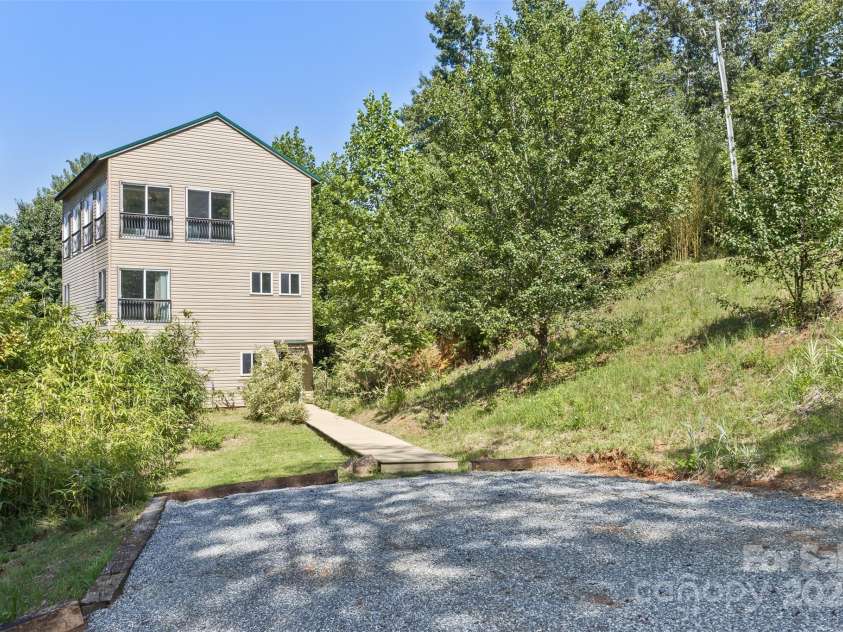 117 Old Dairy Drive, Leicester, NC 28748.  MLS# CAR4291419, YatesRealty ID 34700. This light-filled home, designed with simplicity in mind, is perfect for creating your own homestead. Situated on 2.12 acres, the land lends itself to multiple areas for farming while maintaining privacy through genero