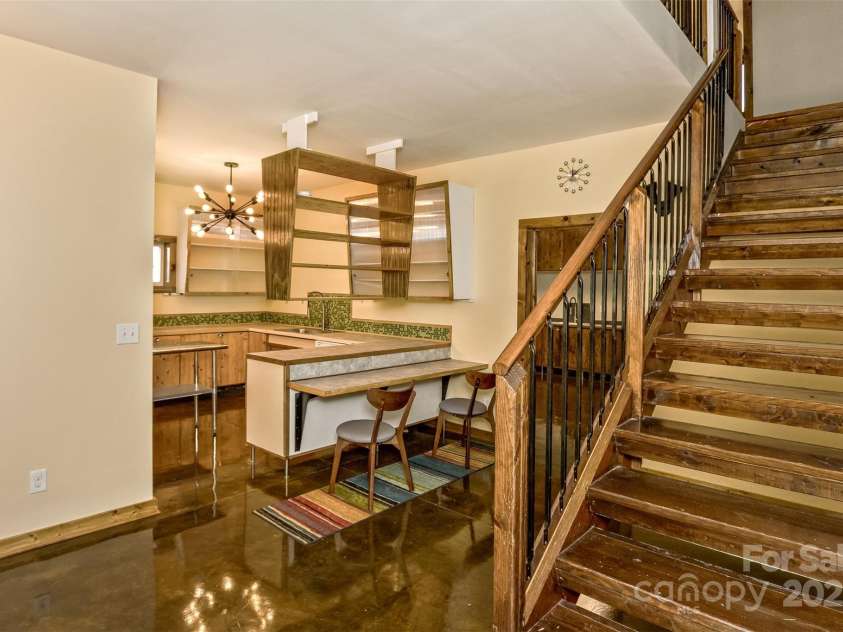 117 Old Dairy Drive, Leicester, NC 28748.  MLS# CAR4291419, YatesRealty ID 34700. Upon entry, you are greeted by an open-concept kitchen which features lots of storage and a cozy breakfast bar that looks into the kitchen.