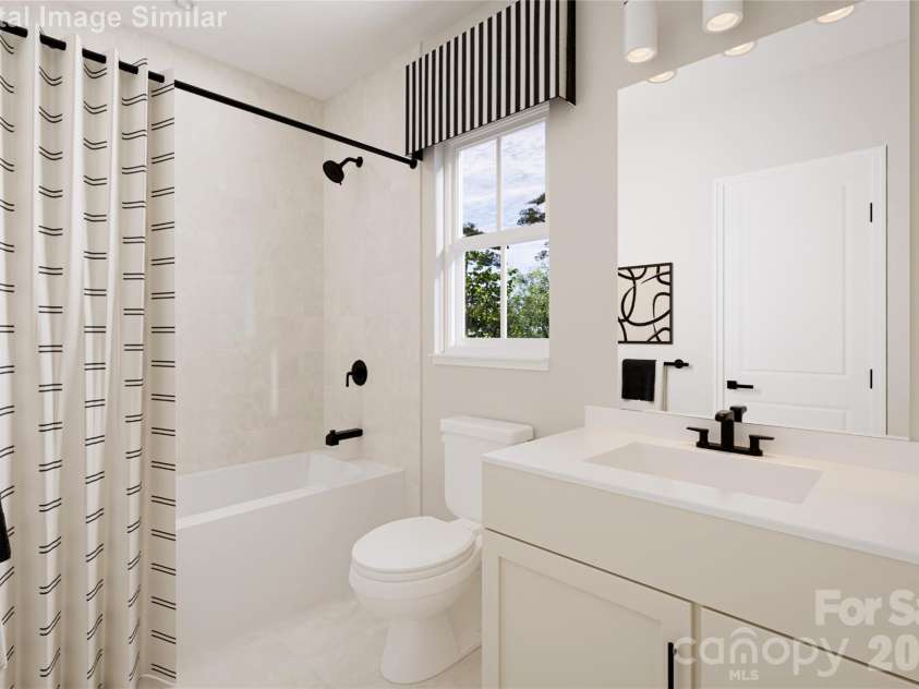 3145 Ravenfield Lane, Charlotte, NC 28213.  MLS# CAR4400180, YatesRealty ID 34708. The shared bathroom features sleek, modern lines and a bright, inviting design, complete with a stylish tub for added comfort and convenience.