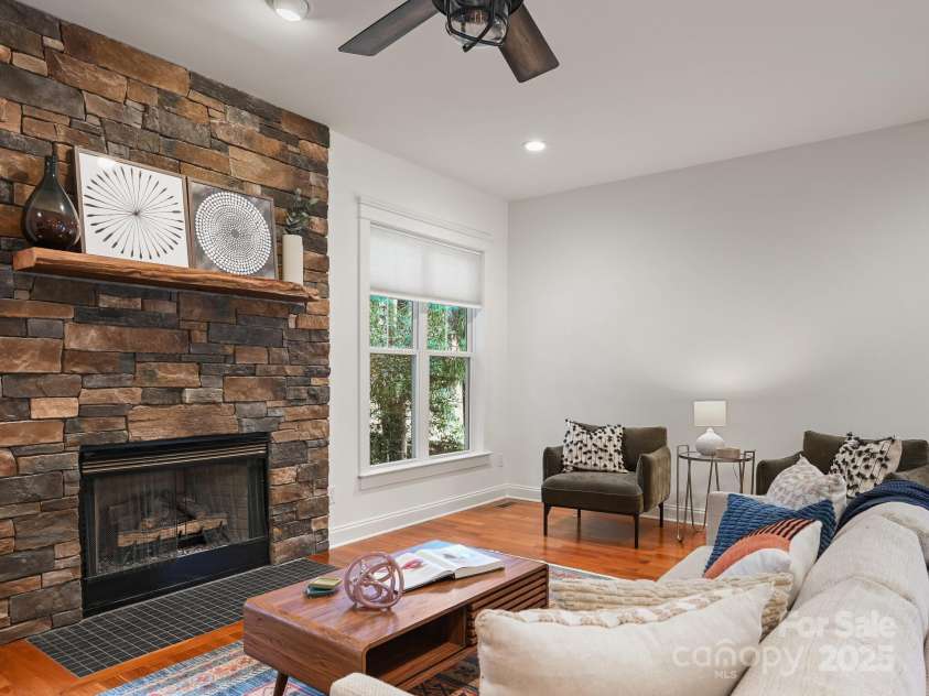 1343 Heathbrook Circle, Asheville, NC 28803.  MLS# CAR4293968, YatesRealty ID 34717. Living room with stone surround gas fireplace
