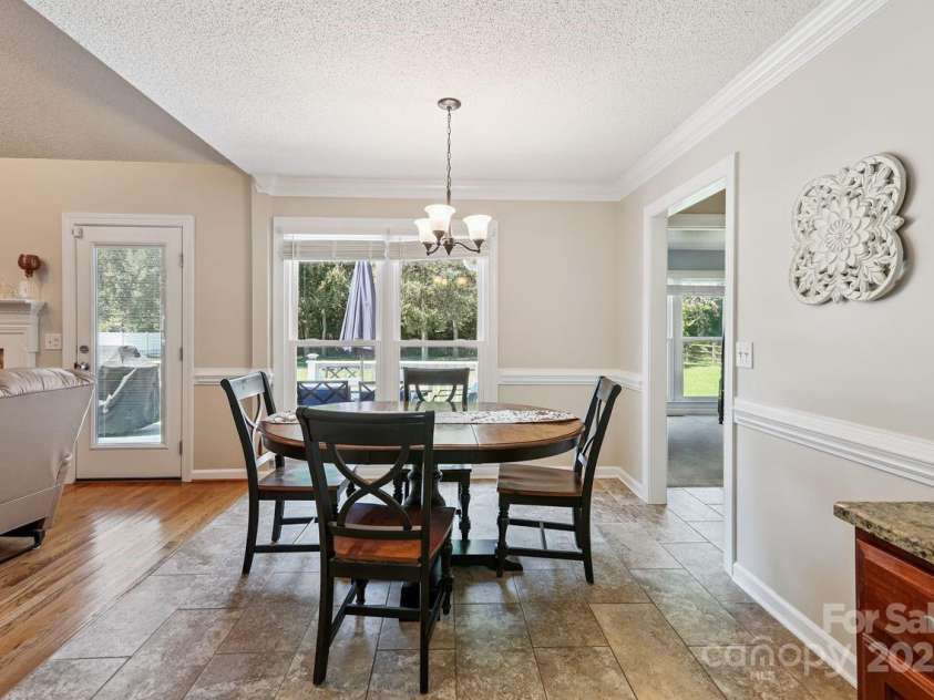8300 Quail Hollow Drive, Harrisburg, NC 28075.  MLS# CAR4295062, YatesRealty ID 34726. Breakfast room opens to kitchen.